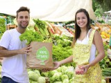 Small business owner selling organic fruits and vegetables.