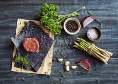 Raw tenderloin steak with seasoning, garlic, and asparagus